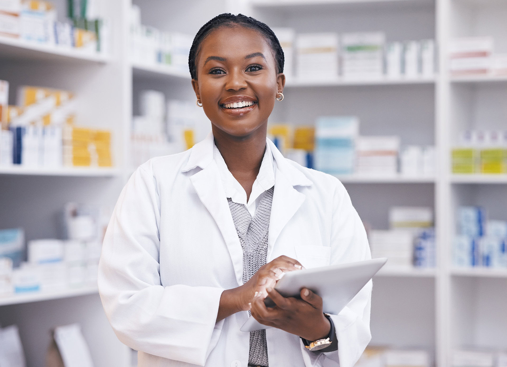 Young woman in pharmacy with tablet