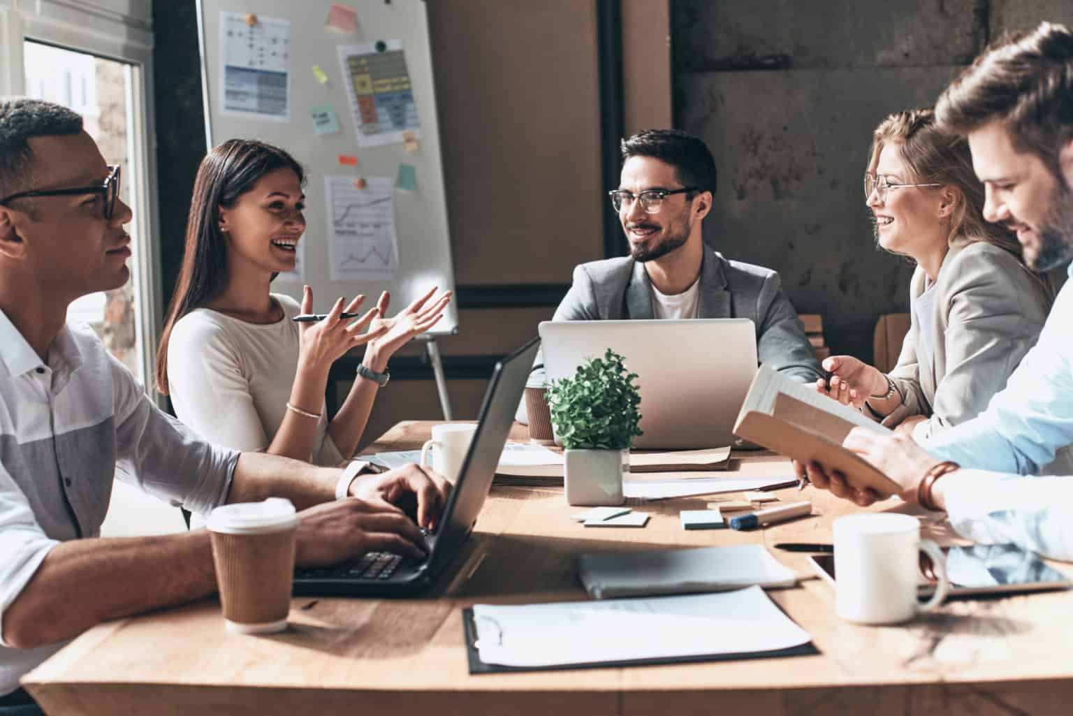 Team meeting to discuss ideas around a table